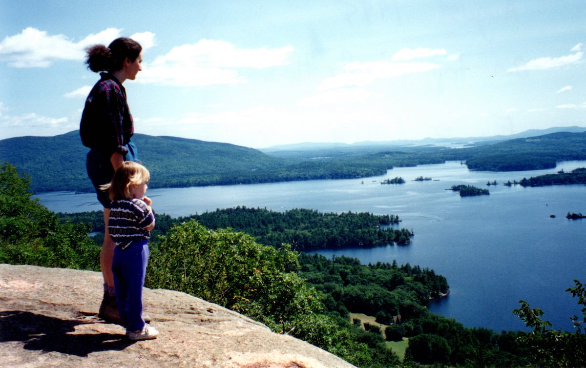 Cathy, in 1995, with daughter Elizabeth, looking at Squam from Rattlesnake.